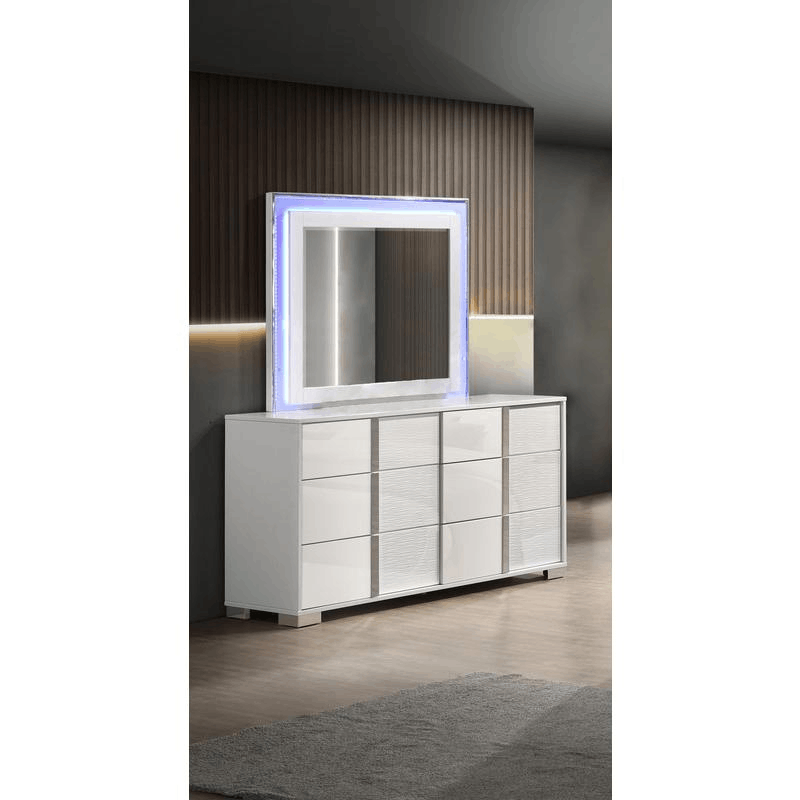 White dresser with six drawers and matching futuristic mirror with LED lighting in modern bedroom setting