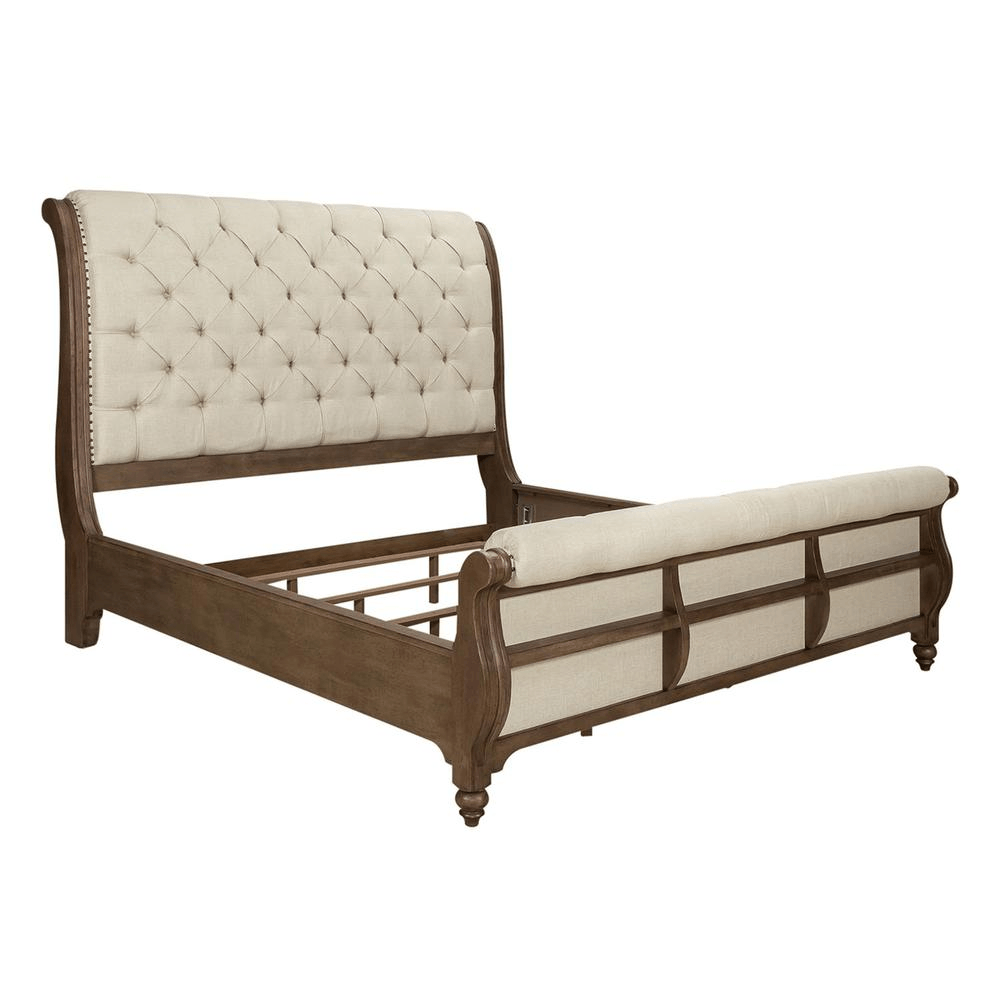 Americana Farmhouse queen sleigh bed with tufted upholstered headboard, wood frame, and nail head accents in dusty taupe finish.