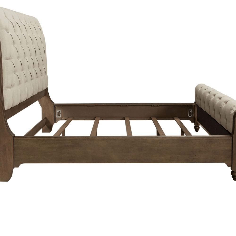 Americana Farmhouse queen sleigh bed with button tufted upholstered headboard and footboard in a wire brushed dusty taupe finish