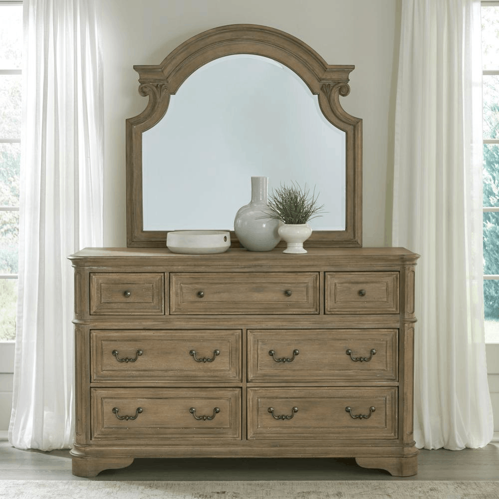 Magnolia Manor dresser and mirror with Weathered Bisque finish, featuring artistic chipping and elegant design in a bedroom setting