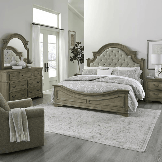 Magnolia Manor king upholstered bed, dresser, mirror, and nightstand in a refined Weathered Bisque finish with Tweed Taupe Mist fabric.